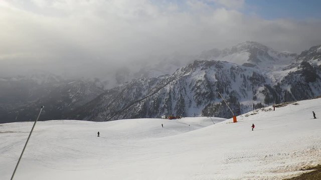 Ski slopes snowy Alpine winter landscape, people skiing