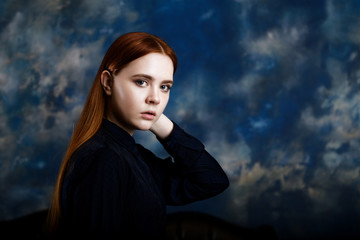 Portrait of a young girl on dark blue background