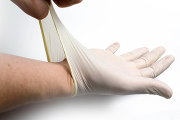 Silicone medical glove put on a hand on a white background