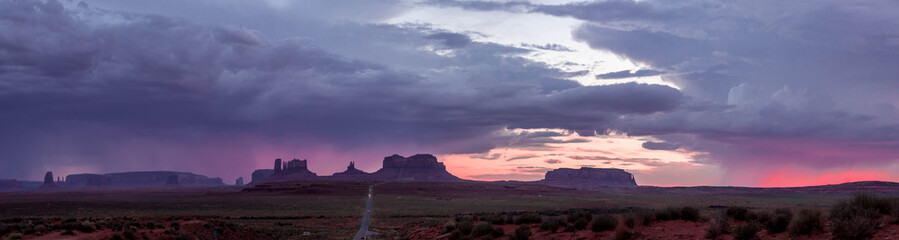 Naklejka na ściany i meble panorama of the highway to monument valley at sunset with purple sky