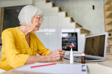 Adult lady is looking on screen at home
