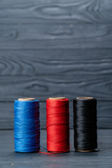 thread coils black red and blue