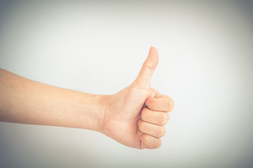 Filtered image studio shot full arm Asian man hand with thumbs up isolated on white