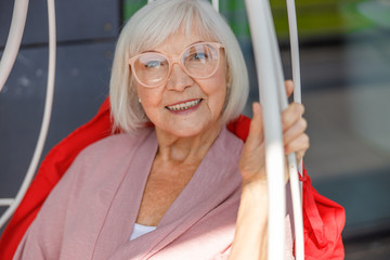 Happy adult woman in glasses posing at camera