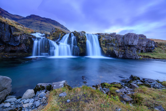 Iceland timelapse photography of waterfall and famous mountain. Kirkjufellsfoss and Kirkjufell in northern Iceland nature landscape © Johannes