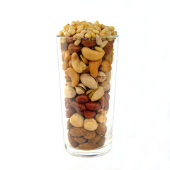 glass cup with nuts on a white background