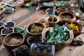 Set of colorful spices in different bowls on wooden table