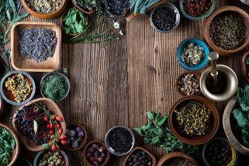 Set of colorful spices in different bowls on wooden table