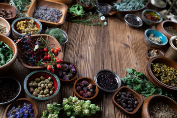 Set of colorful spices in different bowls on wooden table