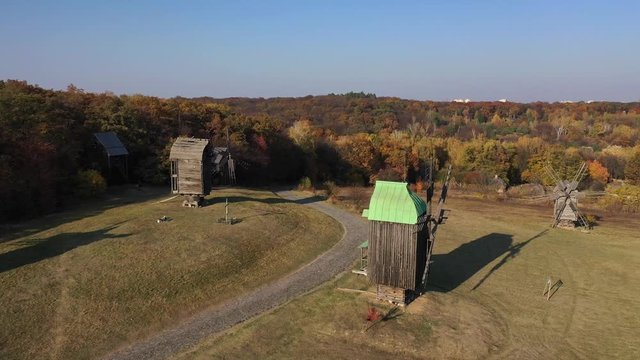 Wooden orthodox church in the village. Paints of golden autumn. Aerial view.