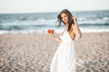 Fototapeta na wymiar Romantic woman walking on beach
