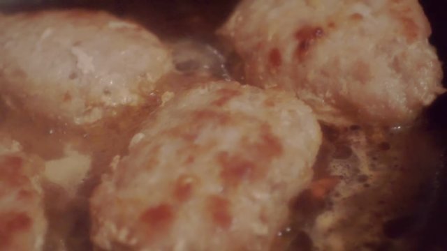 juicy meatballs fried in a metal pan.close-up.shallow depth of field.