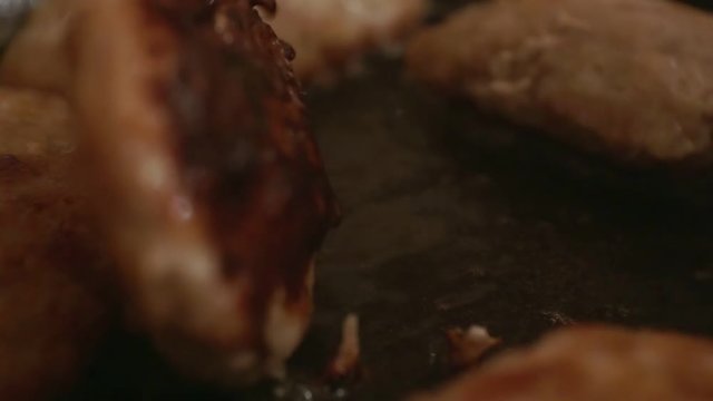 juicy meatballs fried in a metal pan.close-up.shallow depth of field.
