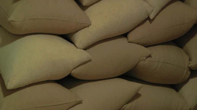 Old hemp sacks stack containing argan tree nuts, close up tilt down