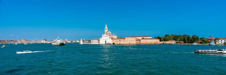 Fototapeta na wymiar Venice. San Giorgio Maggiore Island. Panoramic view of amazing Venetian lagoon on blue sky background. Header. Banner. Space for text. 