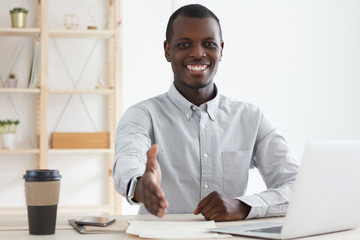 African american hr recruiter or business man extending hand at camera for handshake at office....