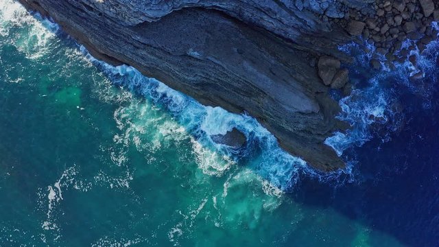 Static shot over sea waves breaking in the reefs and coast, Cantabrian sea, Spain - drone aerial view