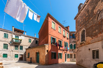 Venice. Colorful laundry is dried on the clothesline between the houses. Ancient Italian city. Travel Tourism in Europe. 