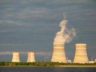Water-cooling towers of nuclear power plant illuminate by sunset light. Udomlya, Russia