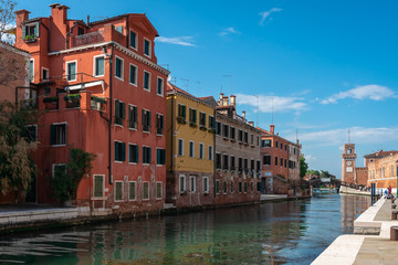 Fototapeta na wymiar Venice. Panoramic view of Venetian colorful houses and canals. Arsenal building on the horizon. Biennale, world modern art exhibition.