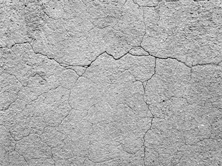 Mur béton brut gris fissure texture