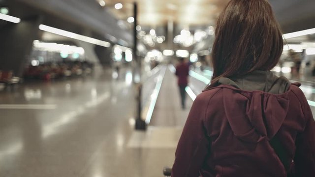 Young Girl Walking to Airport Speedwalk Close up. Beautiful Caucasin Woman Carrying Luggage Cart Move to Boarding Gate. Commuter Go to Modern Travelator. Business or Tourism Trip. Footage Shot in 4K