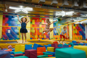 Fototapeta na wymiar Little children having fun on kids trampoline