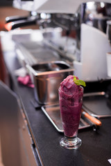 blueberry smoothie top on mint leaf