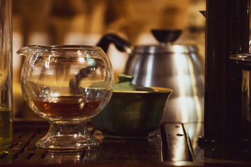 Few lemonade pitchers, kettle and oval glass, during the coffee festival. blurry background