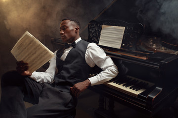 Black pianist with music notebook, jazz musician