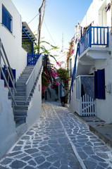 Beautiful romantic narrow backstreet alley lane with typical traditional whitewashed Greek houses in Parikia on the Cyclade Island of Paros