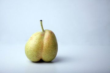 concept of ugly food - pear on light background