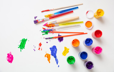 Colorful finger paints set on white color background, top view