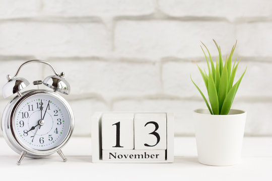 November 13 on the wooden calendar next to the alarm clock, the calendar date of the last autumn month