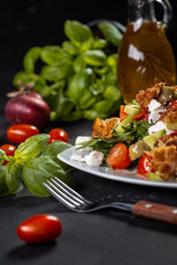 Healthy salade with basil, tomato, olive oil, spanach, feta cheese. Closeup of vegetable