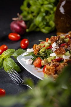 Healthy salade with basil, tomato, olive oil, spanach, feta cheese. Closeup of vegetable