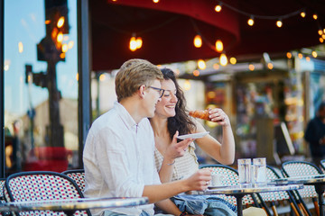 Happy romantic couple in Paris, drinking coffee