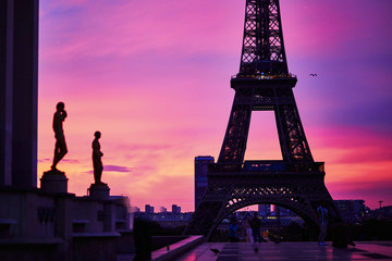 Scenic view of the Eiffel tower with dramatic pink and purple sky during sunrise