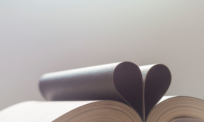 Book with opened pages of shape of heart