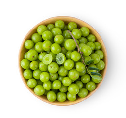 Indian gooseberry in wood bowl isolated on white background. top view