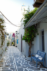 Beautiful romantic narrow backstreet alley lane with typical traditional whitewashed Greek houses in Parikia on the Cyclade Island of Paros