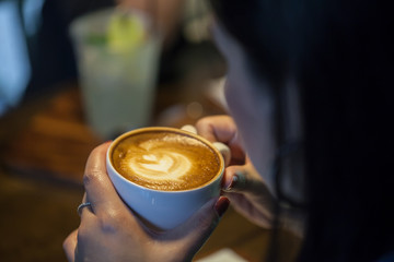 woman hands holding a cup of coffee ,Drinking coffee