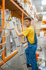 Constructor climbing the stairs in hardware store