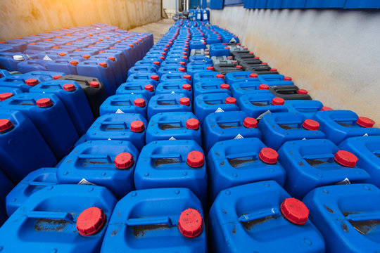 Group oil barrels or chemical of blue plastic gallons,Blue plastic container size 30 liters on the cement floor in the ware house.