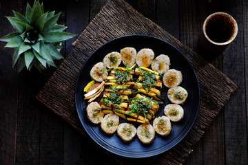 Top view vegan Vietnamese eating indoor restaurant, vegetarian rice rolls cut in slice with vegetable