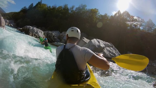 Slow-motion shot of two guys kayaking