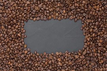 Roasted coffee beans frame background on black with copy space