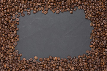 Roasted coffee beans frame background on black with copy space