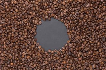 Roasted coffee beans round frame background on black with copy space
