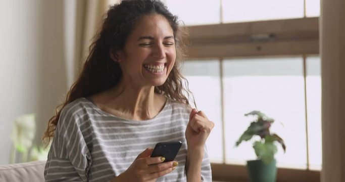 Excited woman hold phone chatting in dating app feel overjoyed